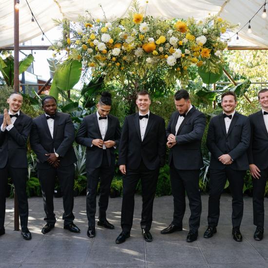 groomsmen under flower cloud