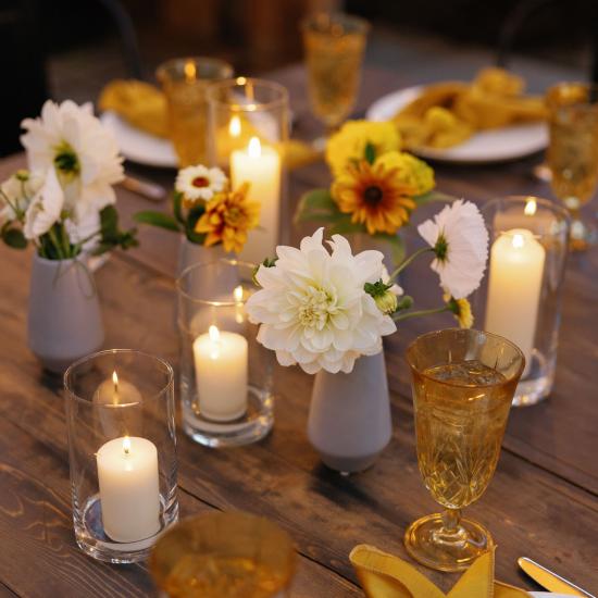 candles and bud vases on dining tables