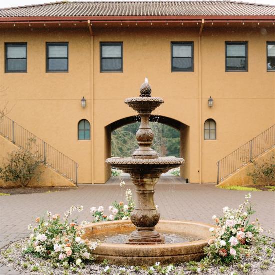 ground flowers surrounding water fountain