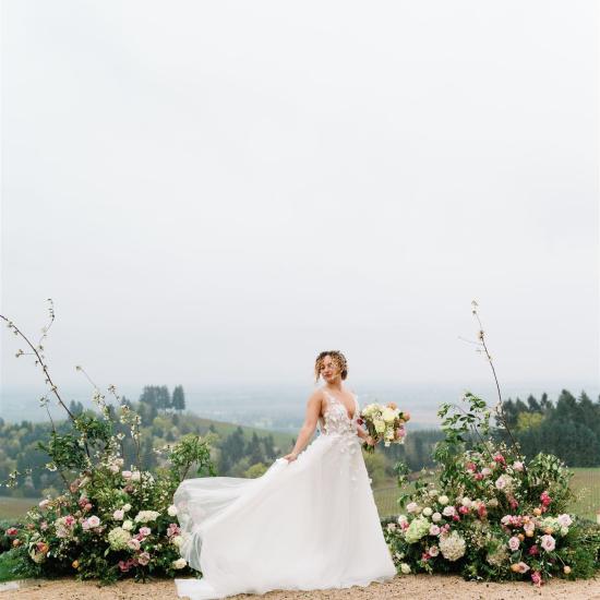 bride in front of ceremony flowers