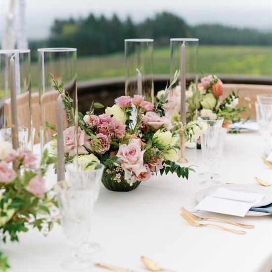 table decor of flowers, candles, and dinnerware