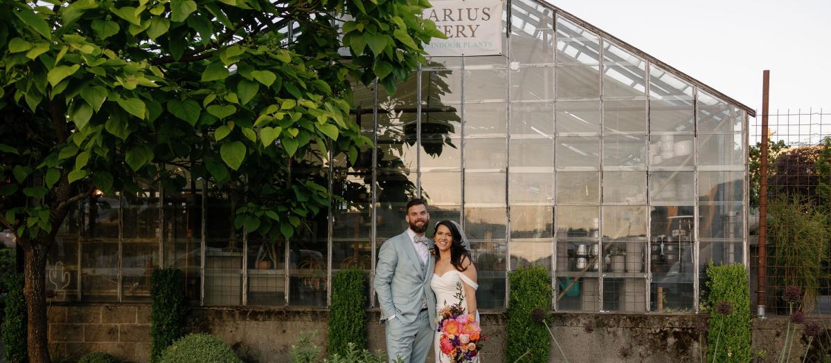 bride and groom in front of nursery